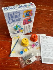 Make a Wind Chime Kit for kids two tiny terra cotta pots, five paints, paint brush, twine, and clear cord to assemble
