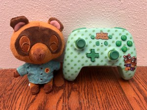 Animal Crossing Nintendo Switch Controller with Timmy and Tommy next to Timmy stuffed animal