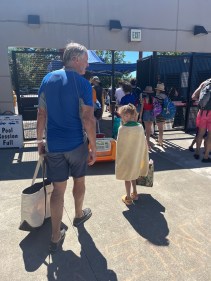 Child wearing orange sorbet color glitter Crocs clogs leaving swimming pool