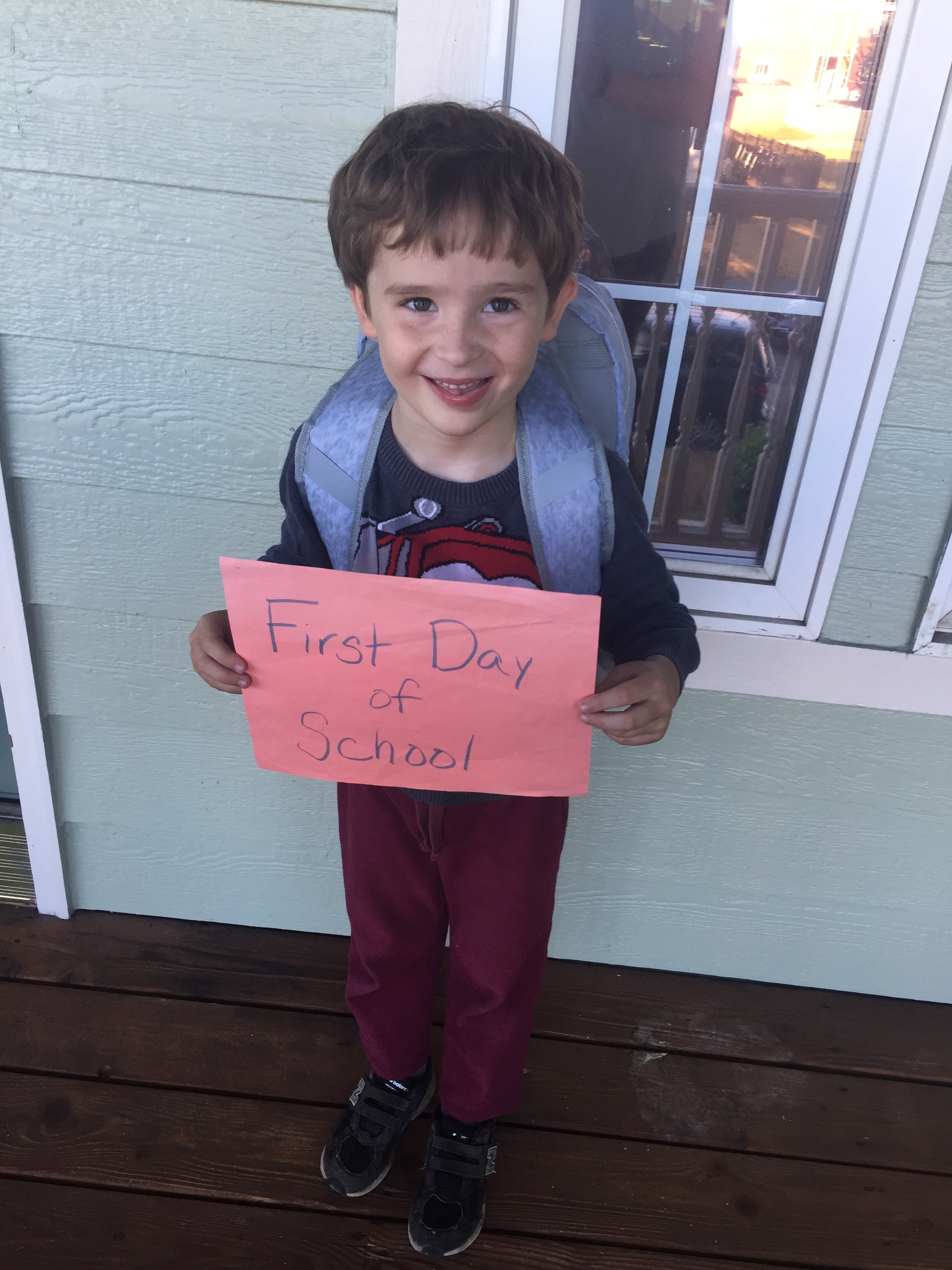 Five year old child wearing new IMG backpack for kids from Target on first day of school 2019
