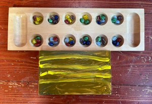 Mancala boards regular and folding shown next to each other