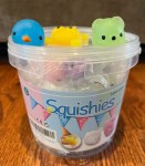 Squishies bucket of soft animals with three squishies on top of lid