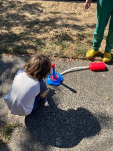 Eight year old child adding bubble liquid solution to base of Bubble Torpedo rocket launcher toy