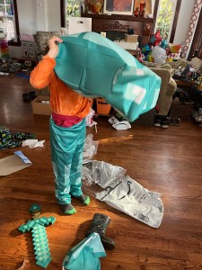 Child putting on Disguise Minecraft Armor Deluxe diamond costume