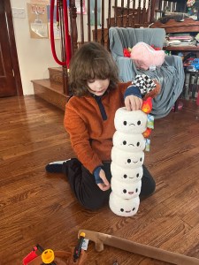 Eight year old playing with Squishables mini comfort food marshmallows plush stuffed toys