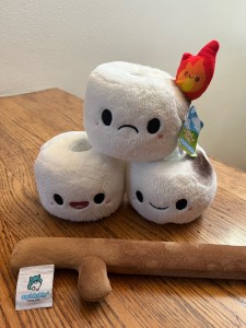 Squishables plush stuffed marshmallows stacked in triangle with removable stick laid in front