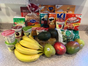 Pile of groceries for family on kitchen counter hauled in Trolley Dolly foldable cart