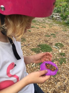 Girl holding purple flower shaped butterly