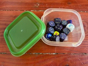 IKEA Pruta small food storage container holding different types of dice