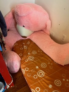 Simmons Kids SlumberTime Naturally 2 Stage Premium Plant Based Soy Foam Crib Mattress with giant pink teddy bear