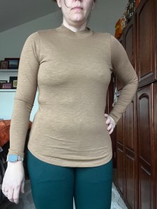 Universal Standard Tori mockneck burnout tee in malt ball brown color shown in real life in 2XS in natural light