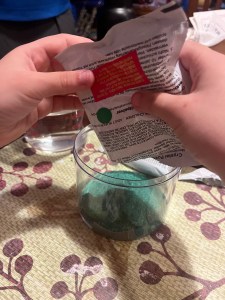 MindWare Crystal Hedgehog growing kit green crystal powder being added to container