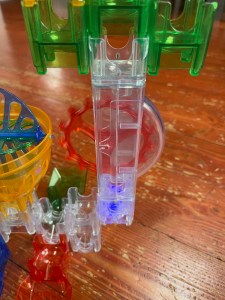 Q-BA-MAZE blue light up block in marble run creation built by eight year old kid