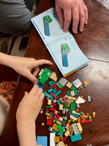 Kid and adult assembling LEGO Set 40654 Beiling postcard set