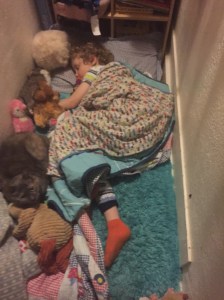 Child sleeping on closet floor in