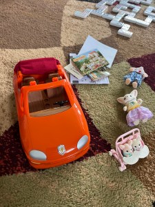Calico Critters Convertible Car in orange with red fabric retractable roof on rug