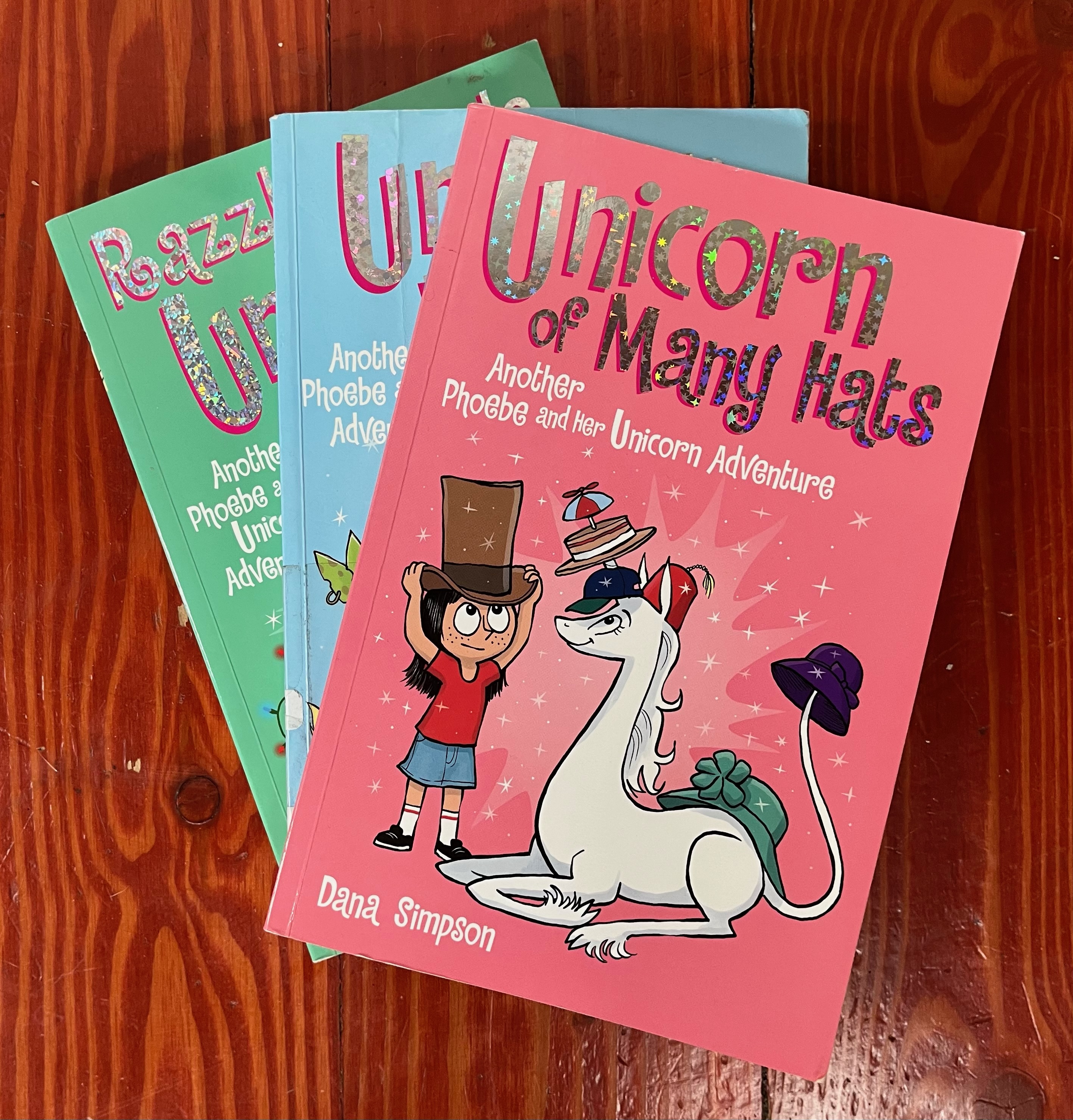 Books from the Phoebe and Her Unicorn graphic novel collection by Dana Simpson