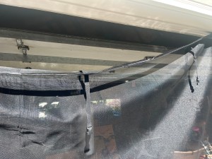 Garage screen door hook and loop sticky tape on top