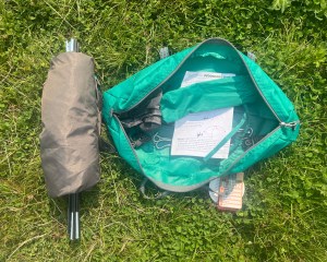 Arcadia Dog Shade Tent small bag and contents including instructions, poles, canvas matereial, and stakes