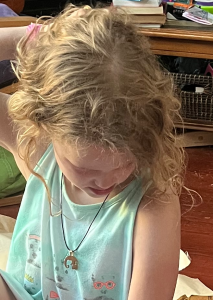 Eleven year old girl wearing dog best friends necklace