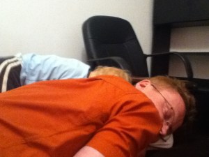 Dad and toddler fast asleep in front of office chair