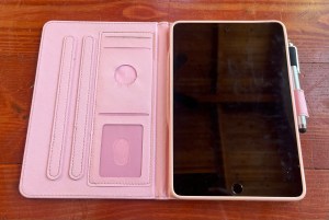 iPad turned off in pink protective case with pockets for id and credit cards