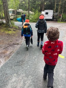 Kids walking in campground wearing REI Rainwall rain pants