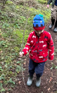 Child hiking with Hatley fleece and REI Rainwall rain pants and boots