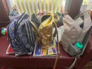 Kids' backpacks lined up in a row ready for school