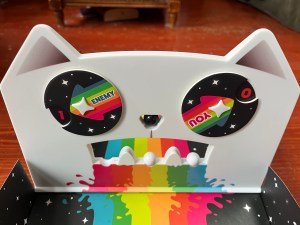 A Game of Cat and Mouth rainbow cat face with cut outs