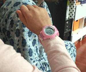 Eight year old child wearing Venhoo pink cartoon unicorn watch on wrist