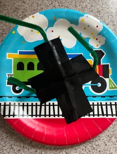 Paper plate for monster eye decoration with pipe cleaner and