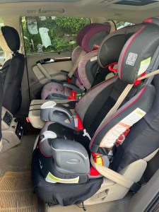 Graco Nautilus 80 Elite next to Britax Grow With Me booster car seat installed in second row of Audi Q7