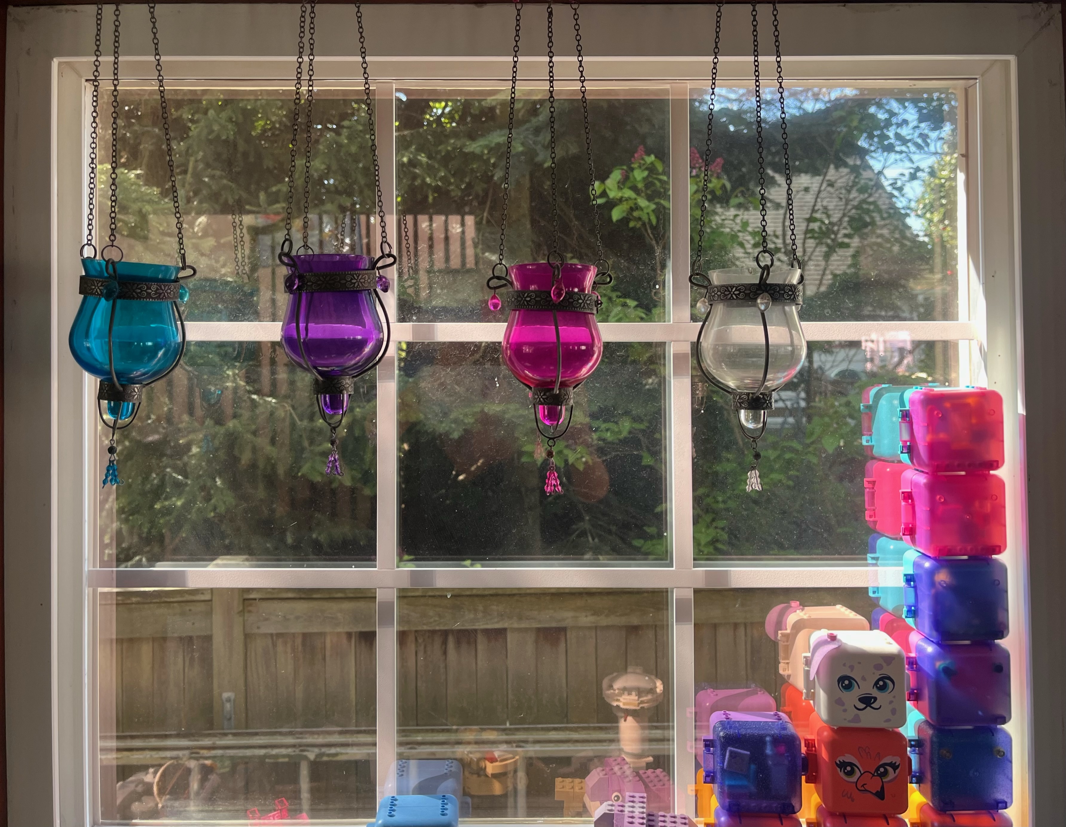 Blue, purple, pink, and clear glass hanging tealight candle holders