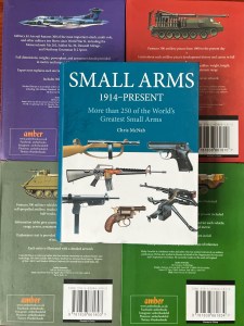Amber Books Mini Miliary Encyclopedias Small Arms 1914-Present on top of purple, red,