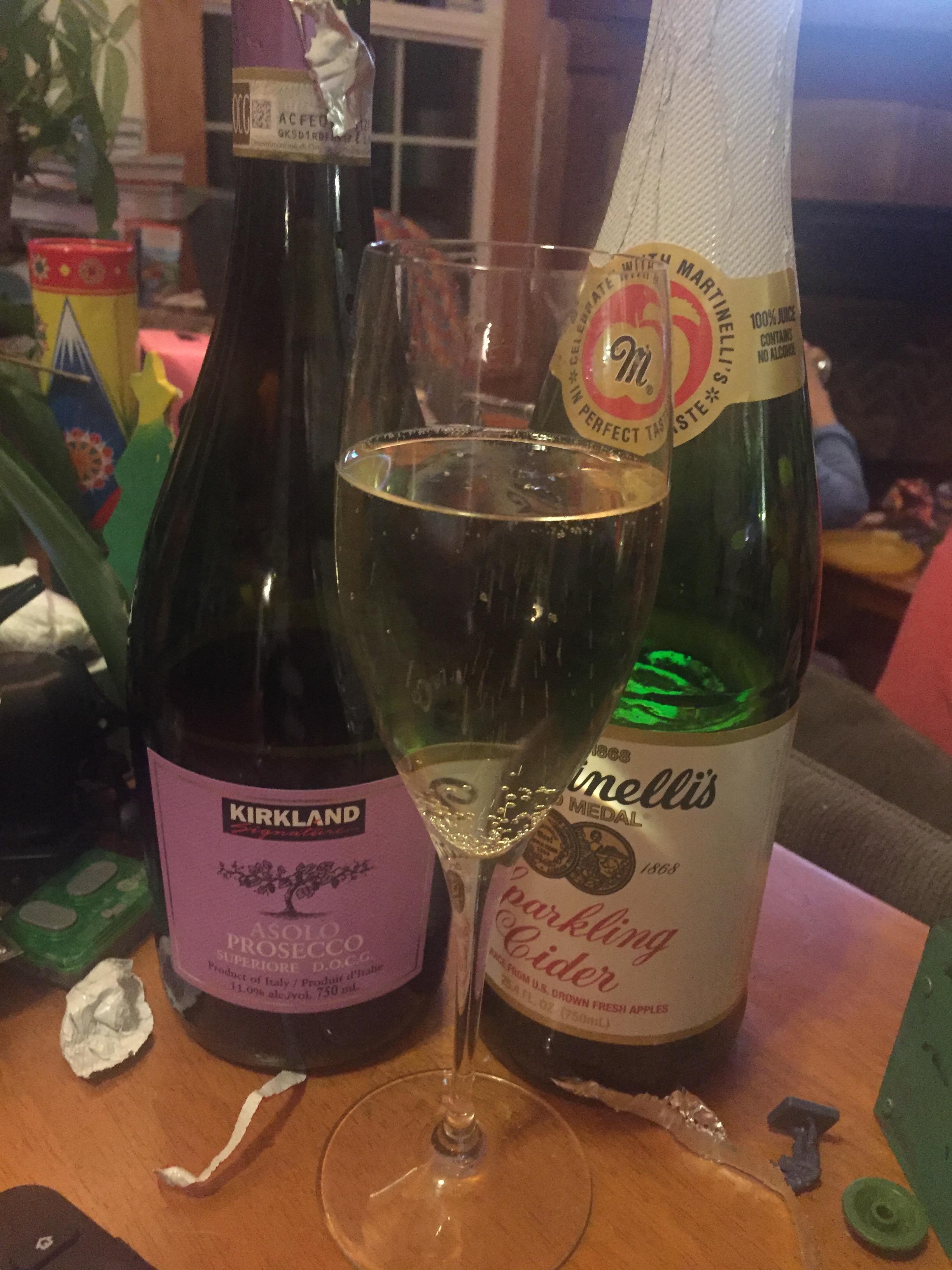 Bubbly drinks in bottles sparkling cider and wine glass