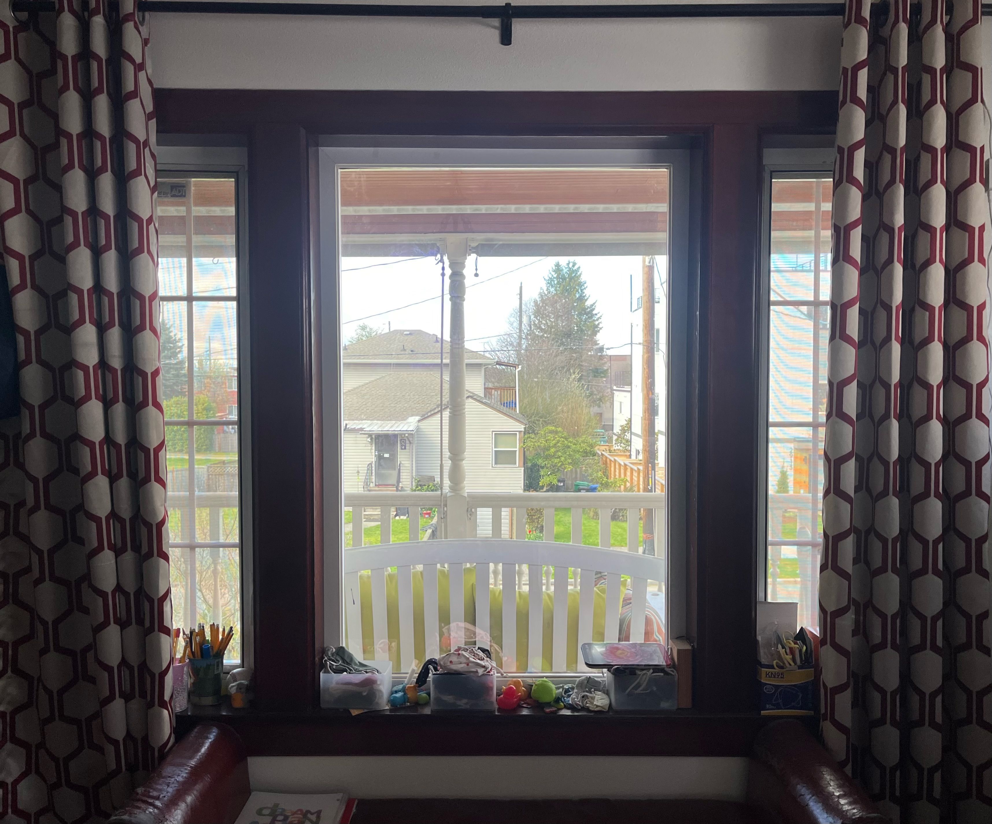 Geometric printed khaki and maroon red blackout curtains frame window