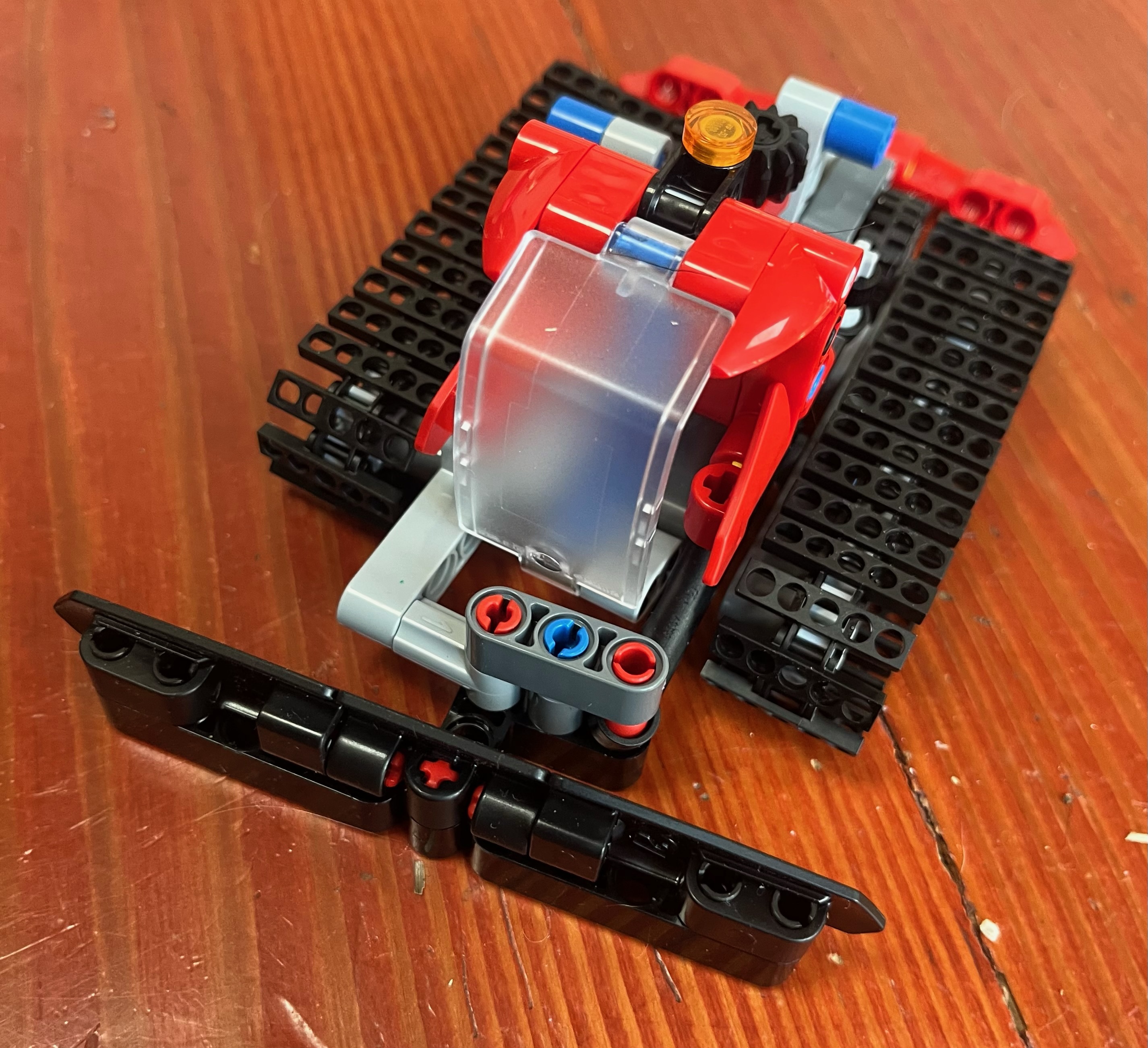 LEGO Technic Snow Groomer toy assembled on hardwood floor